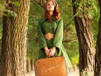 woman with Signature brand luggage